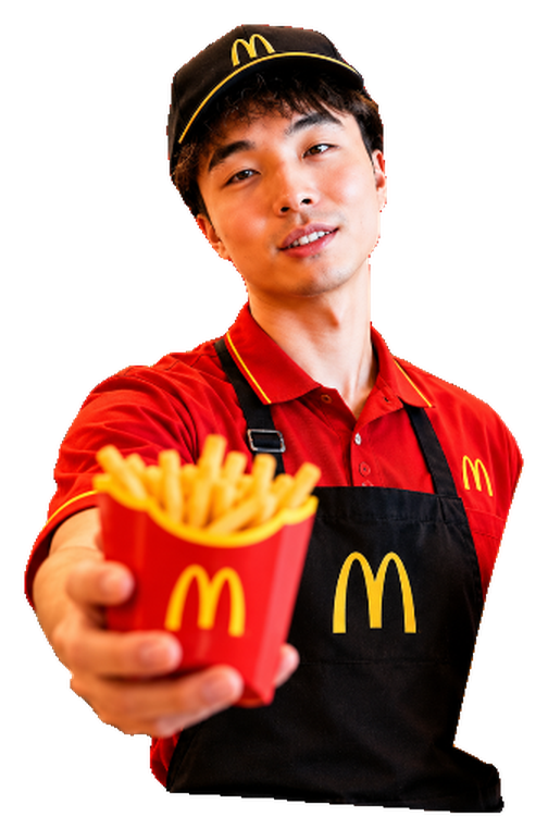 McKimchi in a red uniform, cap and black apron, holding out a carton of fries